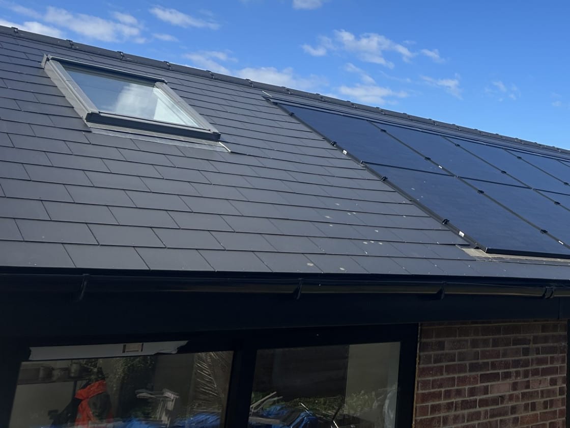 Solar array fitted around a roof window on a bungalow