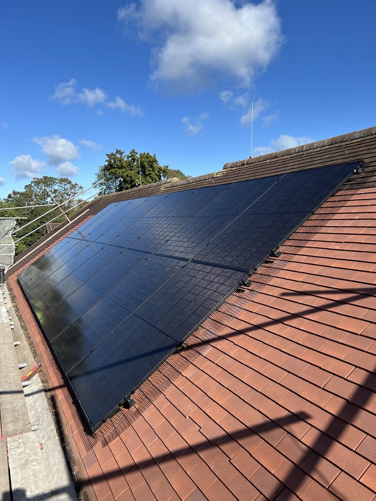 All-black solar panels fitted across a red-tiled roof by Athena